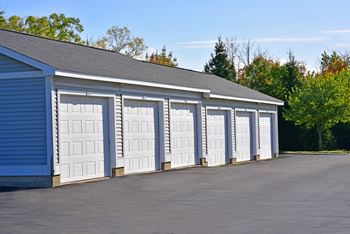 A row of white garage doors are closed.